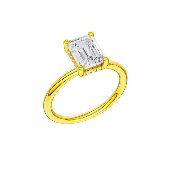 A three-quarter view of the Emerald cut diamond engagement ring in 14k yellow gold with a plain band and solitaire setting