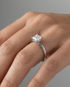 Princess cut diamond engagement ring in 14k white gold with a plain band and solitaire setting on a hand