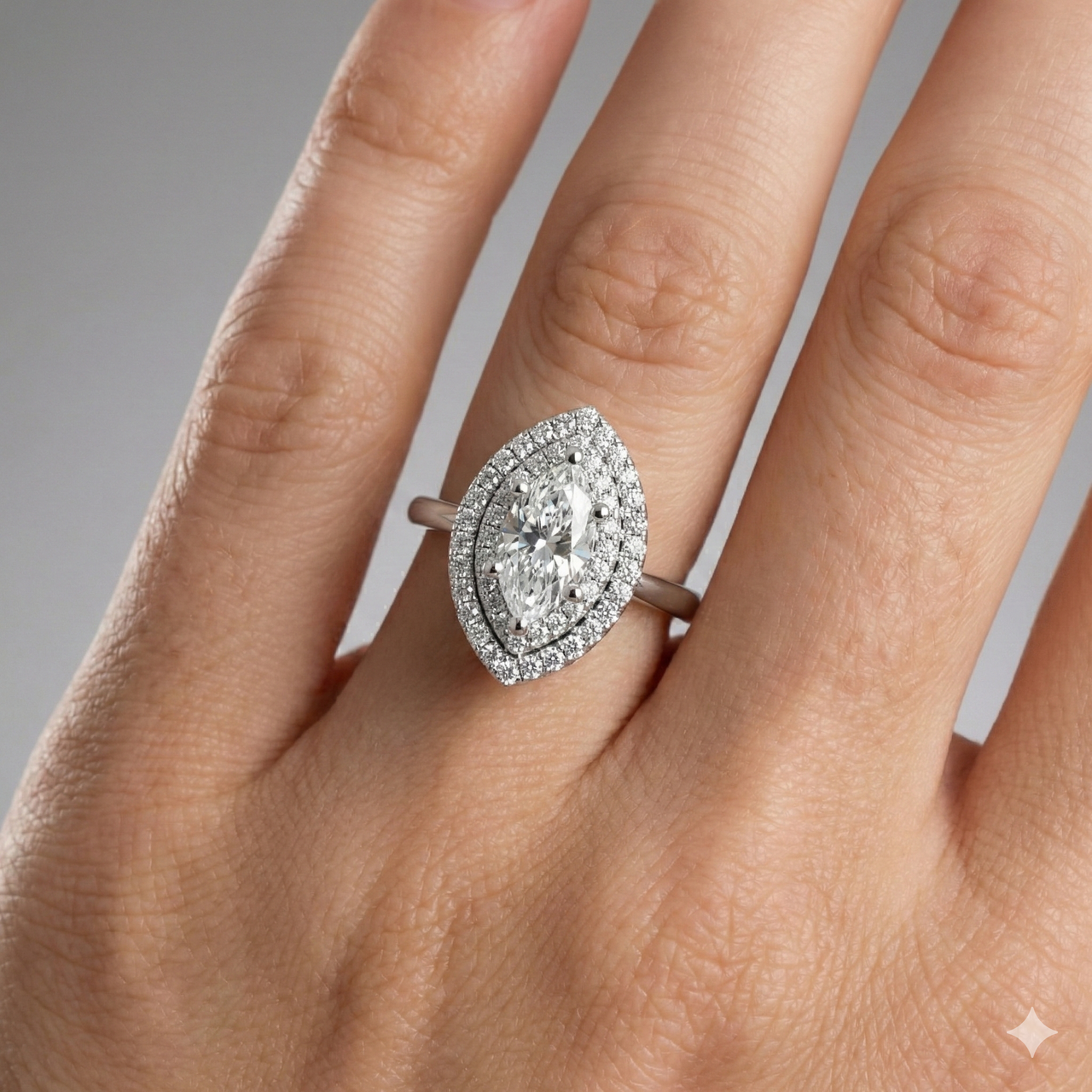 Marquise cut diamond engagement ring in 14k white gold with a plain band and solitaire setting on a hand