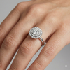 Round cut diamond engagement ring in 14k white gold with a plain band and solitaire setting on a hand