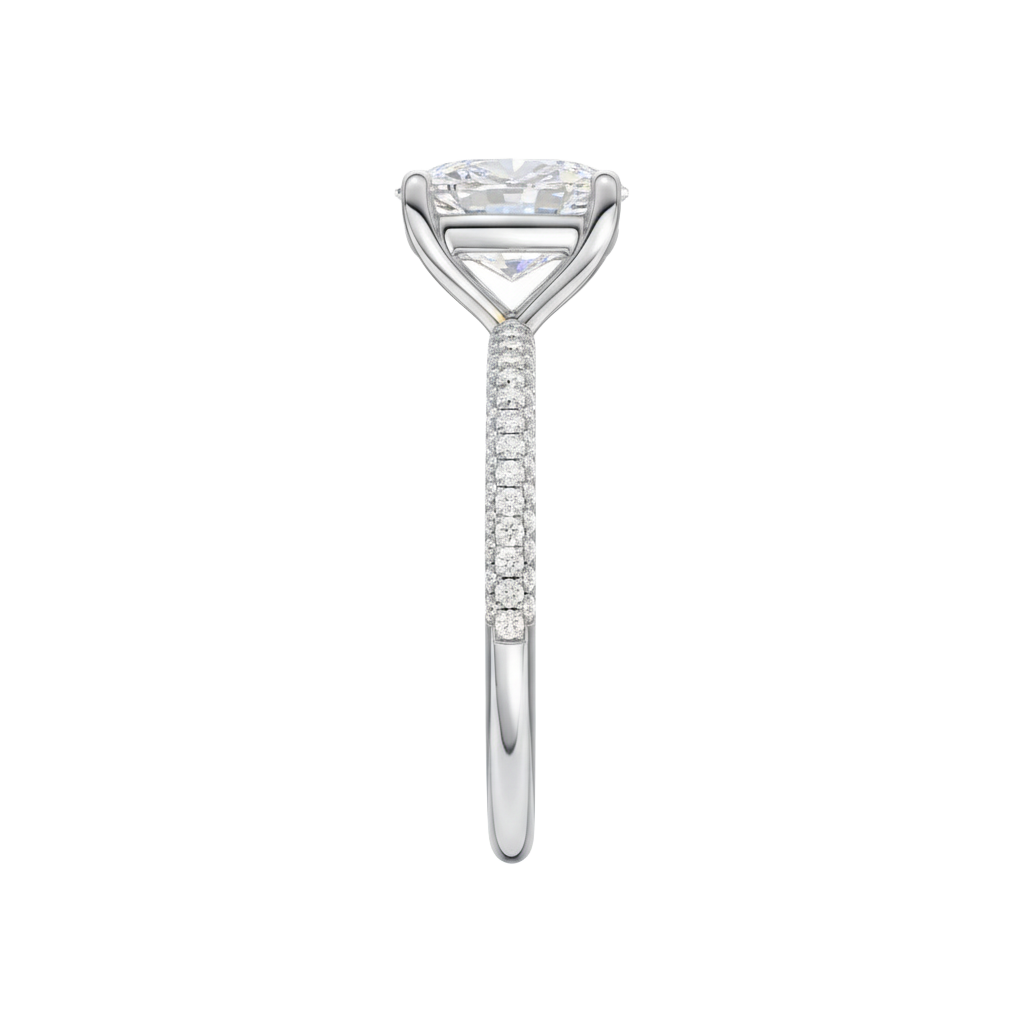 A side view of the Elongated Cushion cut diamond engagement ring in platinum with a pavé diamond band and cathedral setting