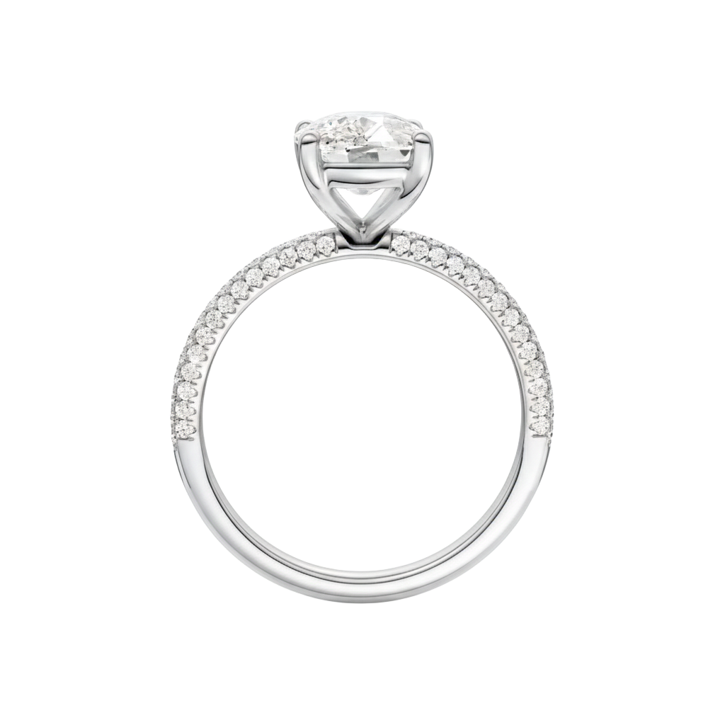 A three-quarter view of the Elongated Cushion cut diamond engagement ring in platinum with a pavé diamond band and cathedral setting
