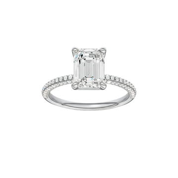 A front view of the Emerald cut diamond engagement ring in 14k white gold with a pavé diamond band and cathedral setting