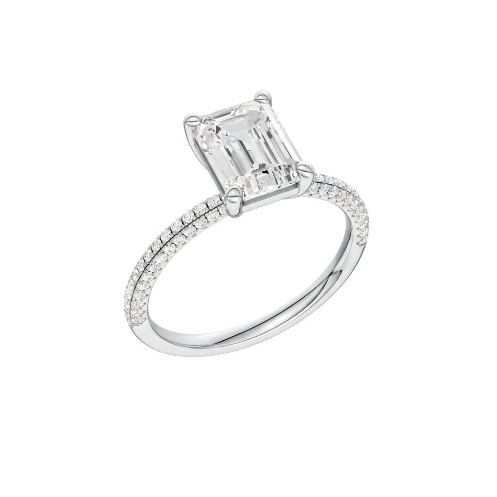 A three-quarter view of the Emerald cut diamond engagement ring in platinum with a pavé diamond band and cathedral setting