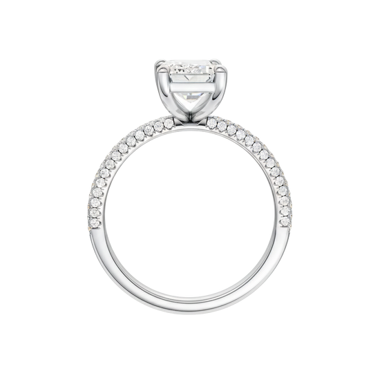 A profile view of the Emerald cut diamond engagement ring in platinum with a pavé diamond band and cathedral setting