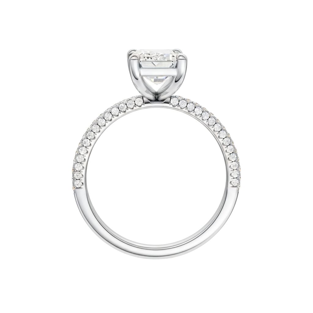 A profile view of the Emerald cut diamond engagement ring in platinum with a pavé diamond band and cathedral setting