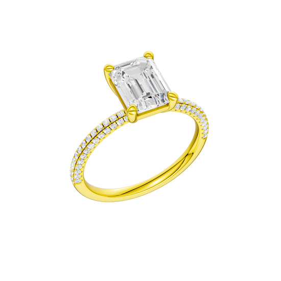 A three-quarter view of the Emerald cut diamond engagement ring in 14k yellow gold with a pavé diamond band and cathedral setting