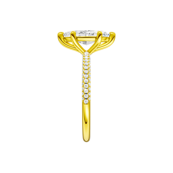 A side view of the Marquise cut diamond engagement ring in 14k yellow gold with a pavé diamond band and cathedral setting