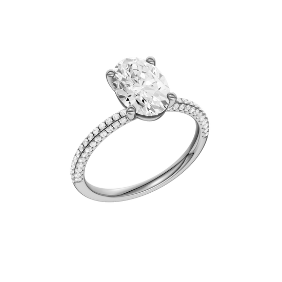A three-quarter view of the oval cut diamond engagement ring in 14k white gold with a pavé diamond band and cathedral setting