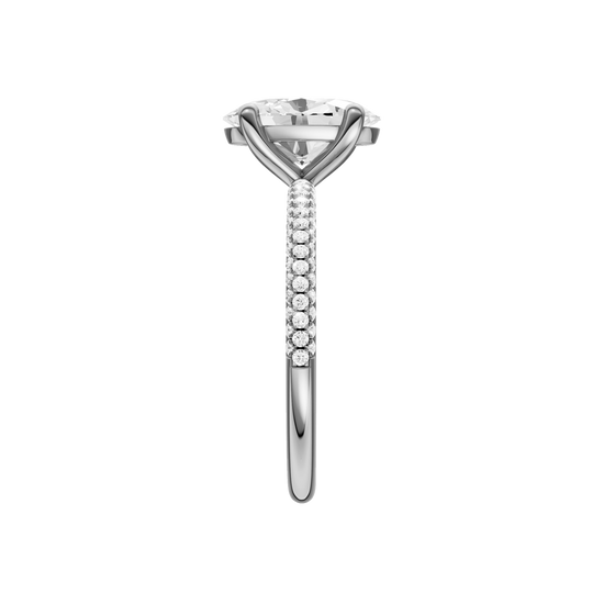 A side view of the oval cut diamond engagement ring in platinum with a pavé diamond band and cathedral setting