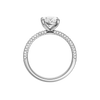 A profile view of the oval cut diamond engagement ring in 14k white gold with a pavé diamond band and cathedral setting