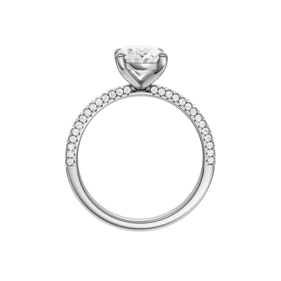 A profile view of the oval cut diamond engagement ring in platinum with a pavé diamond band and cathedral setting