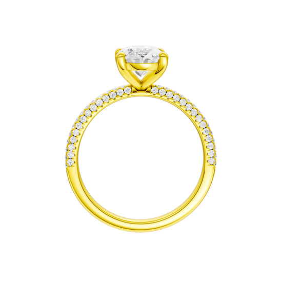 A profile view of the oval cut diamond engagement ring in 14k yellow gold with a pavé diamond band and cathedral setting