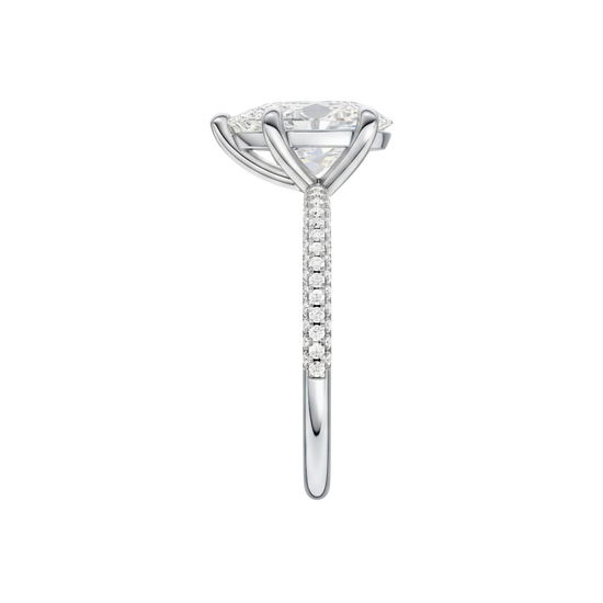 A side view of the Pear cut diamond engagement ring in platinum with a pavé diamond band and cathedral setting