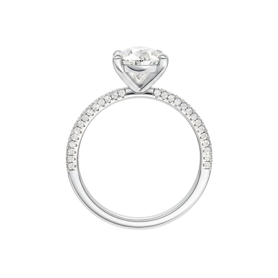 A profile view of the Pear cut diamond engagement ring in platinum with a pavé diamond band and cathedral setting