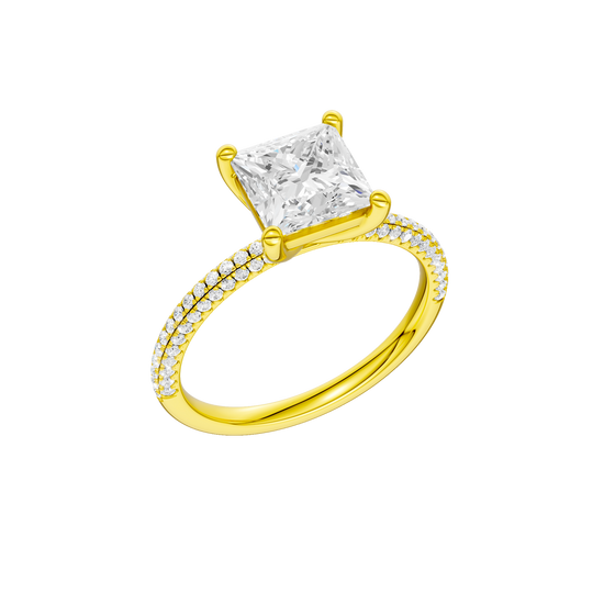 A three-quarter view of the Princess cut diamond engagement ring in 14k yellow gold with a pavé diamond band and cathedral setting