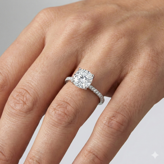 Round cut diamond engagement ring in 14k white gold with a pavé diamond band and cathedral setting on a hand