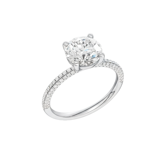 A three-quarter view of the Round cut diamond engagement ring in platinum  with a pavé diamond band and cathedral setting