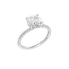 A three-quarter view of the Round cut diamond engagement ring in platinum  with a pavé diamond band and cathedral setting