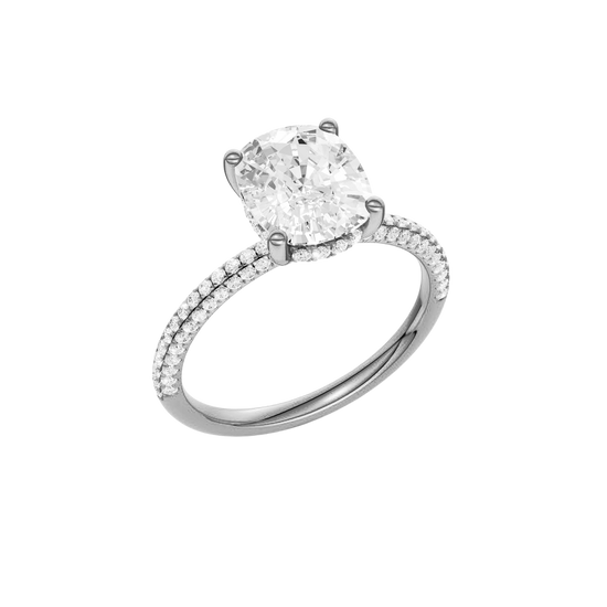 A three-quarter view of the Elongated cushion cut diamond engagement ring in platinum with a pavé diamond band and cathedral setting
