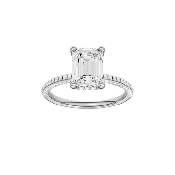 A front view of the Emerald cut diamond engagement ring in 14k white gold with a pavé diamond band and cathedral setting