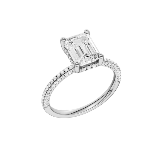A three-quarter view of the Emerald cut diamond engagement ring in 14k white gold with a pavé diamond band and cathedral setting