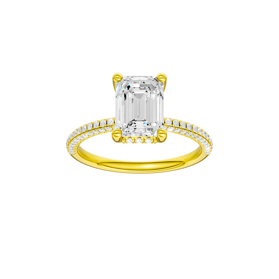 A front view of the Emerald cut diamond engagement ring in 14k yellow gold with a pavé diamond band and cathedral setting