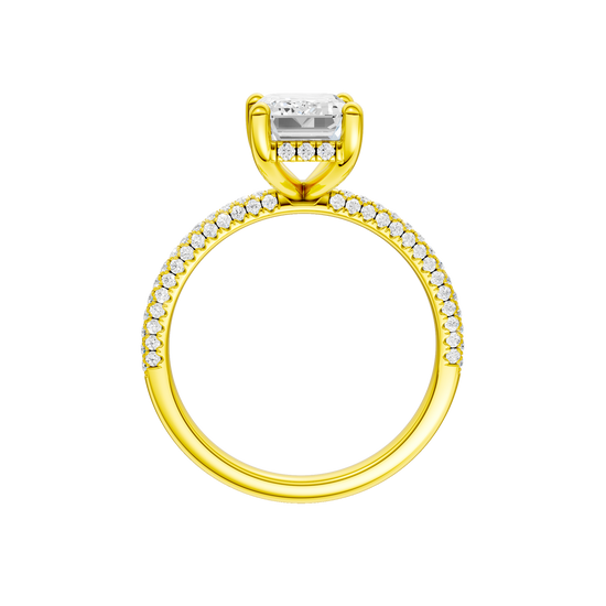 A profile view of the Emerald cut diamond engagement ring in 14k yellow gold with a pavé diamond band and cathedral setting