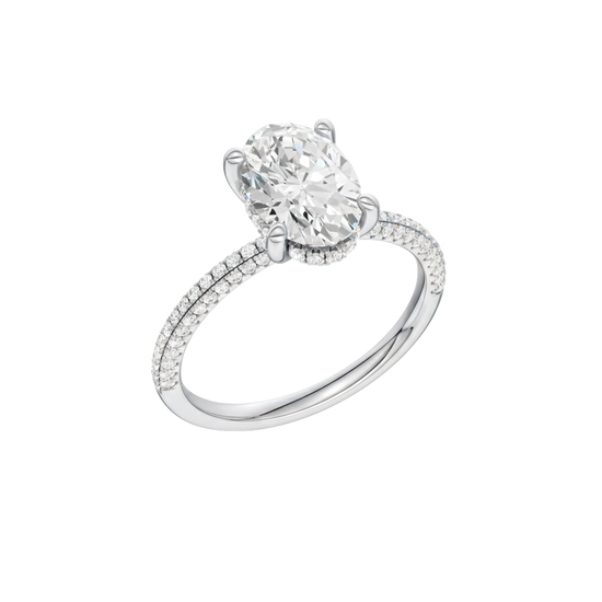 A three-quarter view of the Oval cut diamond engagement ring in platinum with a pavé diamond band and cathedral setting
