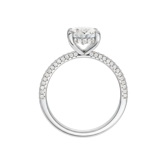 A profile view of the Oval cut diamond engagement ring in 14k white gold with a pavé diamond band and cathedral setting