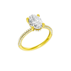 A three-quarter view of the Oval cut diamond engagement ring in 14k yellow gold with a pavé diamond band and cathedral setting