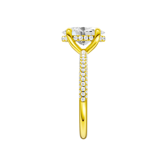 A side view of the Oval cut diamond engagement ring in 14k yellow gold with a pavé diamond band and cathedral setting