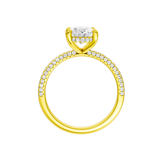 A profile view of the Oval cut diamond engagement ring in 14k yellow gold with a pavé diamond band and cathedral setting
