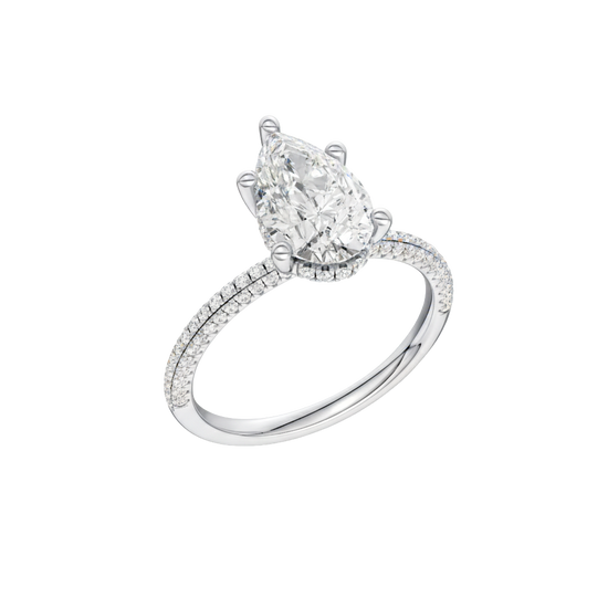 A three-quarter view of the Pear cut diamond engagement ring in 14k white gold with a pavé diamond band and cathedral setting