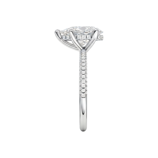 A side view of the Pear cut diamond engagement ring in platinum with a pavé diamond band and cathedral setting