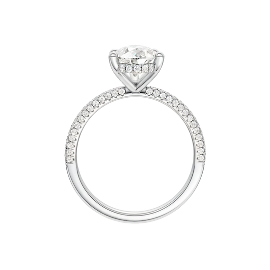 A profile view of the Pear cut diamond engagement ring in platinum with a pavé diamond band and cathedral setting