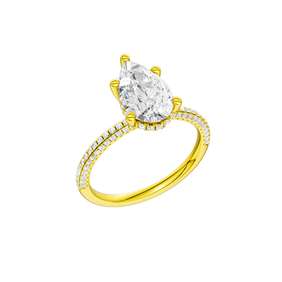 A three-quarter view of the Pear cut diamond engagement ring in 14k yellow gold with a pavé diamond band and cathedral setting