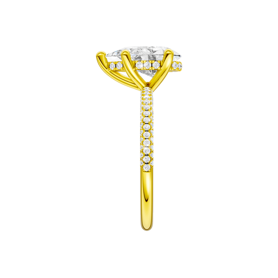 A side view of the Pear cut diamond engagement ring in 14k yellow gold with a pavé diamond band and cathedral setting
