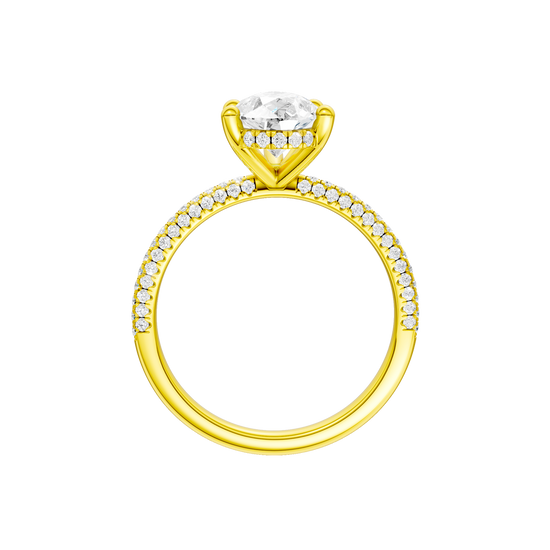 A profile view of the Pear cut diamond engagement ring in 14k yellow gold with a pavé diamond band and cathedral setting