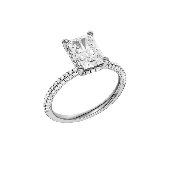 A three-quarter view of the Radiant cut diamond engagement ring in 14k white gold with a pavé diamond band and cathedral setting