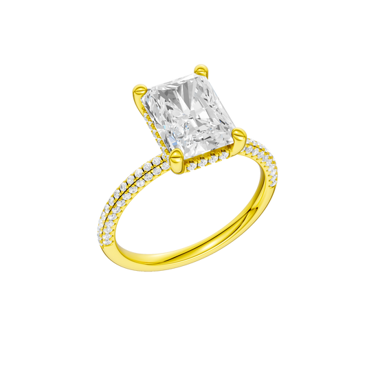 A three-quarter view of the Radiant cut diamond engagement ring in 14k yellow gold with a pavé diamond band and cathedral setting