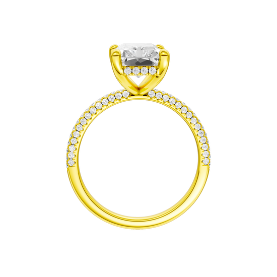 A profile view of the Radiant cut diamond engagement ring in 14k yellow gold with a pavé diamond band and cathedral setting
