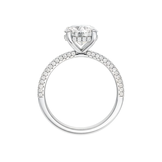 A profile view of the Round cut diamond engagement ring in platinum with a pavé diamond band and cathedral setting