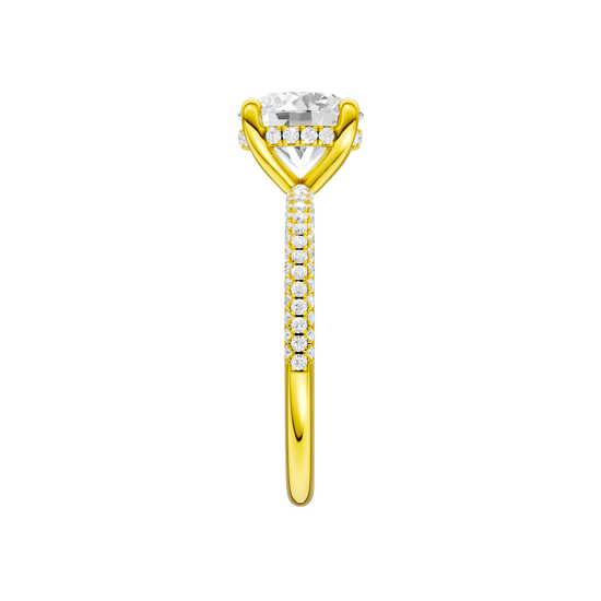 A side view of the Round cut diamond engagement ring in 14k yellow gold with a pavé diamond band and cathedral setting