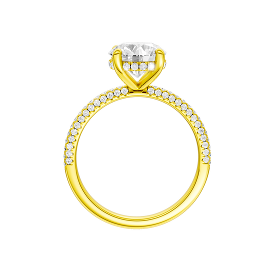 A profile view of the Round cut diamond engagement ring in 14k yellow gold with a pavé diamond band and cathedral setting