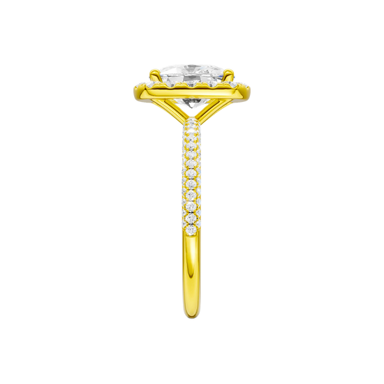 A side view of the Elongated cushion cut diamond engagement ring in 14k yellow gold with a pavé diamond band and solitaire setting