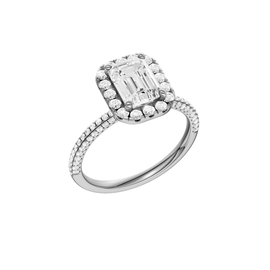 A three-quarter view of the Emerald cut diamond engagement ring in 14k white gold with a pavé diamond band and solitaire setting