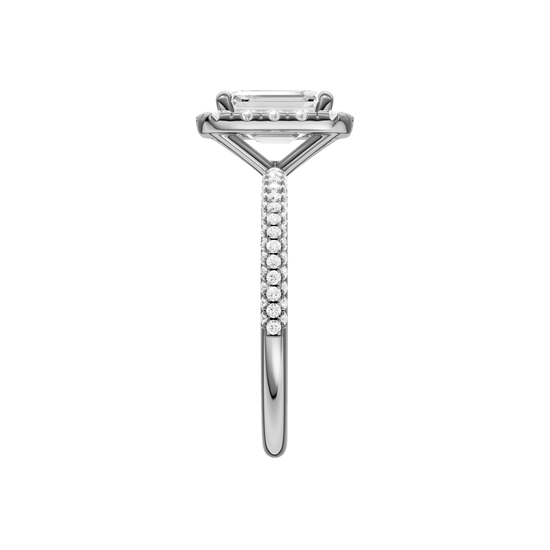 A side view of the Emerald cut diamond engagement ring in 14k white gold with a pavé diamond band and solitaire setting