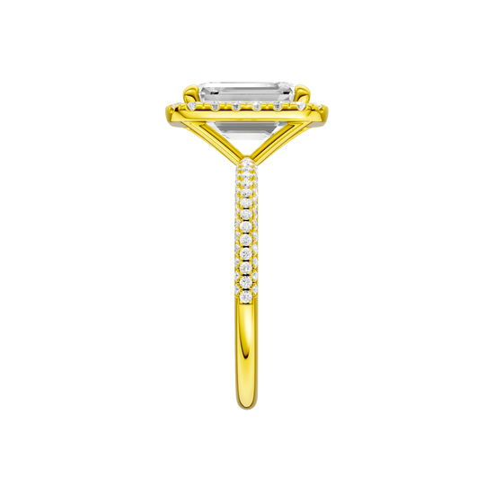 A side view of the Emerald cut diamond engagement ring in 14k yellow gold with a pavé diamond band and solitaire setting