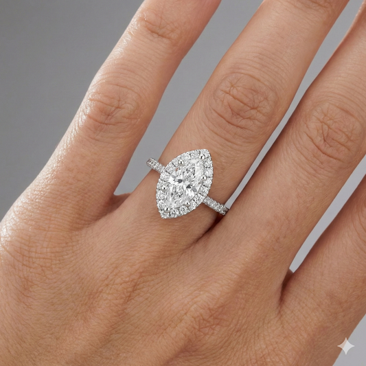 Marquise cut diamond engagement ring in 14k white gold with a pavé diamond band and solitaire setting on a hand